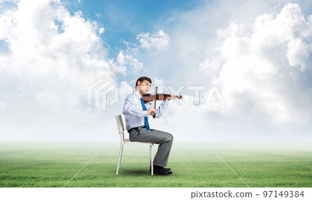young businessman playing violin young businessman playing violin 97149384