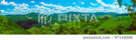 huge horizontal wide panorama of green Italian hills sunny day background huge horizontal wide panorama of green Italian hills sunny day background 97149806