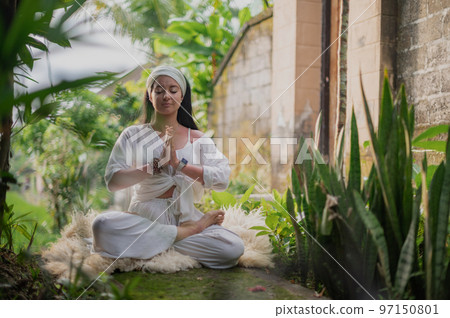 Girl practice yoga meditation outdoor in park 97150801