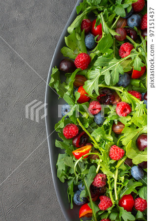 Salad of arugula and fresh berries Salad of arugula and fresh berries 97151437