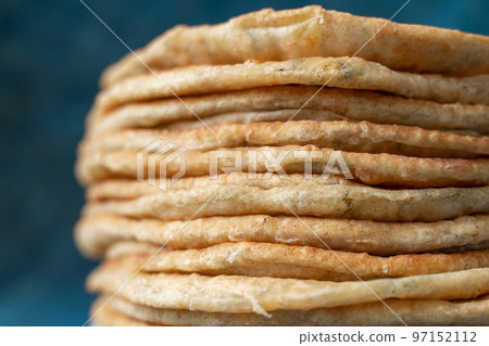 Flatbread lavash, chapati, naan, heap of tortilla on a blue background Homemade flatbread stacked. 97152112