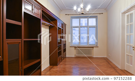An empty room with a large window, rent, sale and furniture made of natural wood An empty room with a large window, rent, sale and furniture made of natural wood 97152288