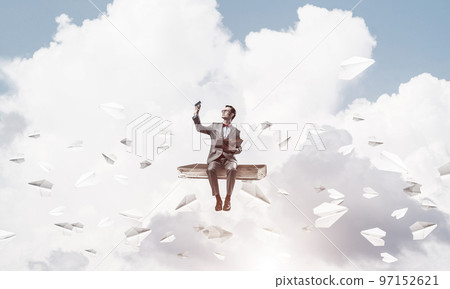 Young businessman or student wearing red glasses studying the science Young businessman or student wearing red glasses studying the science 97152621