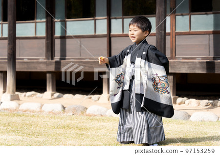 A 5-year-old Japanese boy taking a commemorative photo wearing a hakama at Shichigosan 97153259