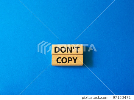 Don't copy symbol. Wooden blocks with words Don't copy. Beautiful blue background. Business and Don't copy concept. Copy space. 97153471