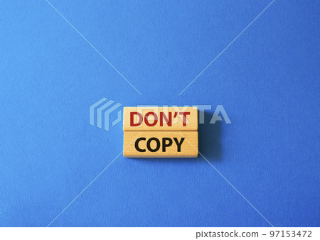 Don't copy symbol. Wooden blocks with words Don't copy. Beautiful blue background. Business and Don't copy concept. Copy space. 97153472