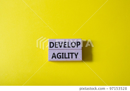 Develop agility symbol. Concept word Develop agility on wooden blocks. Beautiful yellow background. Business and Develop agility concept. Copy space Develop agility symbol. Concept word Develop agility on wooden blocks. Beautiful yellow background. Business and Develop agility concept. Copy space 97153528