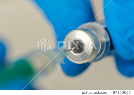 doctor hands injecting a syringe needle into a small bottle with a vaccine or drug assign virus or flu. 97153695