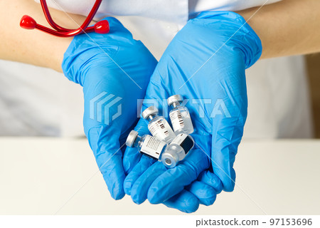 doctor holds in hands small ampoules of Covid-19 vaccine doctor holds in hands small ampoules of Covid-19 vaccine 97153696