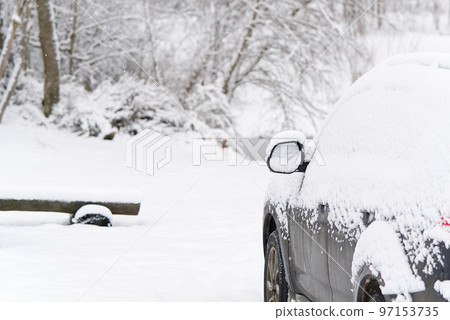 suv Car is all covered with snow at winter morning in country side. Concept of driving in winter time with snow on road. 97153735
