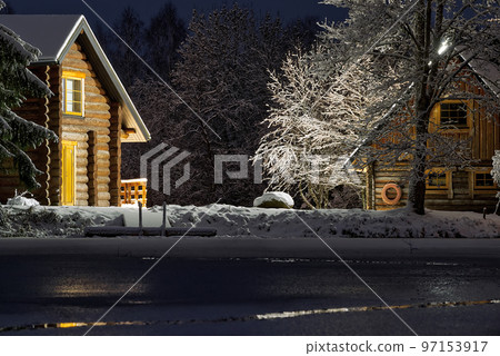 Wooden log cabin at winter night. Country house in winter evening can be used as postcard, wallpaper or poster Wooden log cabin at winter night. Country house in winter evening can be used as postcard, wallpaper or poster 97153917