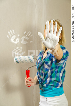 Hand print made with white paint on drywall. painter have fun Hand print made with white paint on drywall. painter have fun 97154073