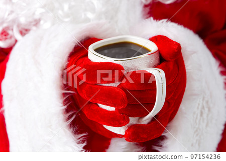 Santa claus holding white mug with coffee in his hand, close-up. 97154236