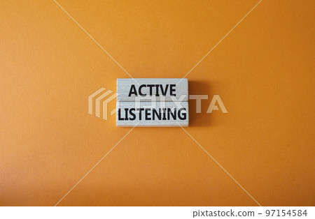 Active listening symbol. Wooden blocks with words Active listening. Beautiful orange background. Business and Active listening concept. Copy space. 97154584