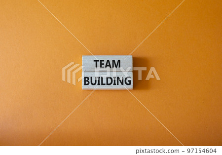 Team Building symbol. Concept word Team Building on wooden blocks. Beautiful orange background. Business and Team Building concept. Copy space Team Building symbol. Concept word Team Building on wooden blocks. Beautiful orange background. Business and Team Building concept. Copy space 97154604
