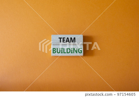 Team Building symbol. Concept word Team Building on wooden blocks. Beautiful orange background. Business and Team Building concept. Copy space Team Building symbol. Concept word Team Building on wooden blocks. Beautiful orange background. Business and Team Building concept. Copy space 97154605