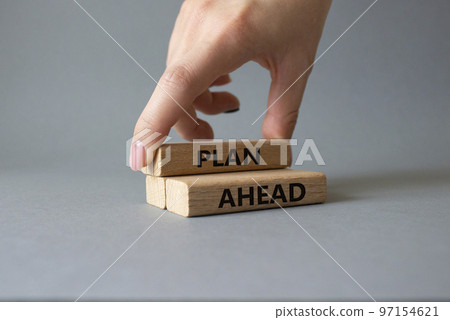 Plan ahead symbol. Wooden blocks with words Plan ahead. Beautiful grey background. Businessman hand. Business and 'Plan ahead' concept. Copy space. Plan ahead symbol. Wooden blocks with words Plan ahead. Beautiful grey background. Businessman hand. Business and 'Plan ahead' concept. Copy space. 97154621