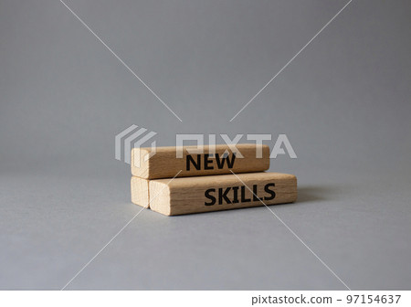 New skills symbol. Wooden blocks with words New skills. Beautiful grey background. Business and New skills concept. Copy space. 97154637