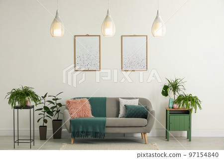 Soft pillows on grey sofa in living room Soft pillows on grey sofa in living room 97154840