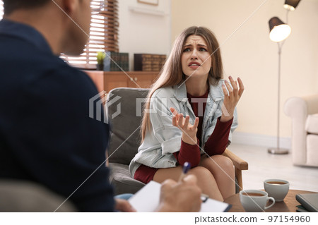 Professional psychotherapist working with patient in office Professional psychotherapist working with patient in office 97154960