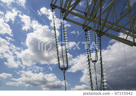 Electricity pylon (high voltage power line) on the background of the cloudy sky 97155042