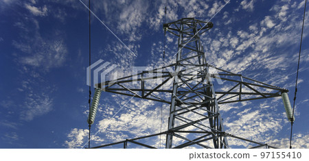 Electricity pylon (high voltage power line) on the background of the cloudy sky 97155410