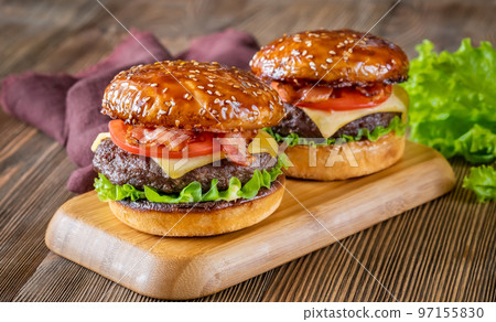 Hamburgers on the wooden board Hamburgers on the wooden board 97155830
