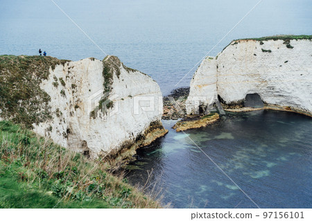 Beautiful white rocks on the background of the sea. Winter coastline landscape. White Old Harry Rocks, England. Travel and holidays destinations. Selective focus, copy space. 97156101