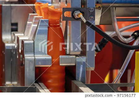 The orange bottle container manufacturing process by blow mold machine. 97156177