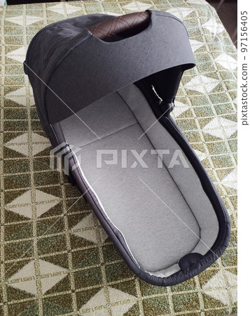 a bassinet from a stroller in a separate room 97156405