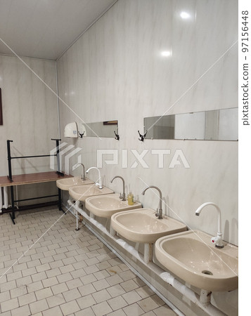 old faucets and sinks in a public toilet old faucets and sinks in a public toilet 97156448