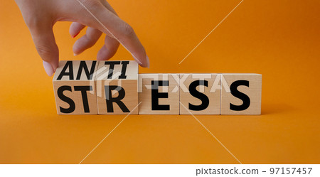 Antistress vs stress symbol. Concept words Antistress vs stress on wooden cubes. Beautiful orange background. Doctor hand. Antistress vs stress concept. Copy space Antistress vs stress symbol. Concept words Antistress vs stress on wooden cubes. Beautiful orange background. Doctor hand. Antistress vs stress concept. Copy space 97157457