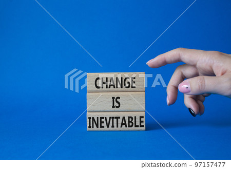 Change is Inevitable symbol. Wooden blocks with words Change is Inevitable. Beautiful blue background. Businessman hand. Business and Change is Inevitable concept. Copy space. Change is Inevitable symbol. Wooden blocks with words Change is Inevitable. Beautiful blue background. Businessman hand. Business and Change is Inevitable concept. Copy space. 97157477