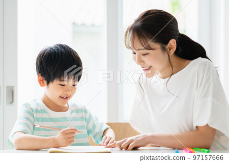 Boy and mother studying in the living room 97157666