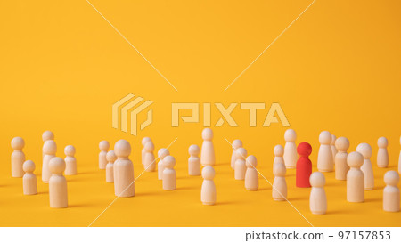 A red wooden figurine of a person is in a crowd of figurines on a yellow background 97157853