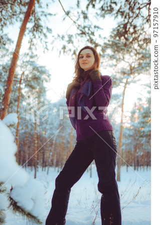 Young woman enjoying winter weather in the snow forest. 97157910