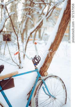 Old antique bike covered with snow in winter time Old antique bike covered with snow in winter time 97157956