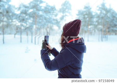 Young woman enjoying winter weather in the snow forest. Young woman enjoying winter weather in the snow forest. 97158049