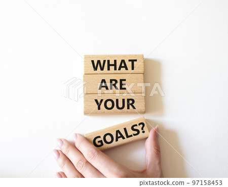 Goals symbol. Concept words What are your goals on wooden blocks. Beautiful white background. Businessman hand. Business and What are your goals concept. Copy space. 97158453