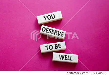 You deserve to be well symbol. Wooden blocks with words You deserve to be well. Beautiful red background. You deserve to be well concept. Copy space. 97158505