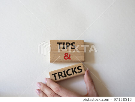 Tips and tricks symbol. Wooden blocks with words Tips and tricks. Beautiful white background. Businessman hand. Business concept and Tips and tricks. Copy space. Tips and tricks symbol. Wooden blocks with words Tips and tricks. Beautiful white background. Businessman hand. Business concept and Tips and tricks. Copy space. 97158513