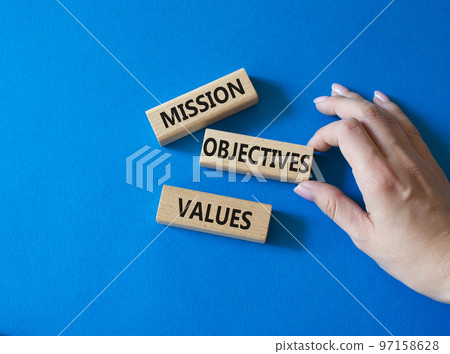 Mission Objectives Values symbol. Concept words Mission Objectives Values on wooden blocks. Beautiful blue background. Businessman hand. Business and Mission Objectives Values concept. Copy space Mission Objectives Values symbol. Concept words Mission Objectives Values on wooden blocks. Beautiful blue background. Businessman hand. Business and Mission Objectives Values concept. Copy space 97158628