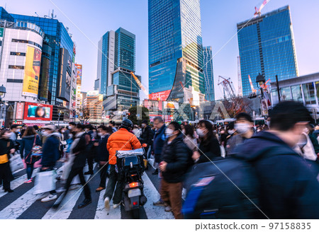 The cityscape of Tokyo in Japan, the rush of December... food delivery on a motorcycle that "pushes through" the crowd... = Shibuya 97158835