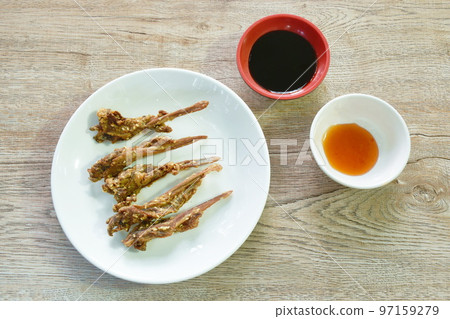 deep fried duck beak with white sesame dipping chili and black sweet soy sauce on plate 97159279