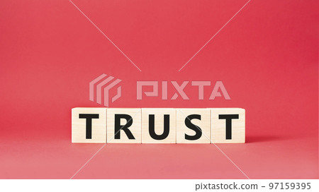 Trust symbol. Concept word Trust on wooden cubes. Beautiful red background. Business and Trust concept. Copy space. 97159395
