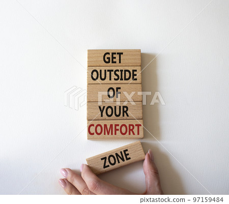 Get outside of your comfort zone symbol. Concept words Get outside of your comfort zone on wooden blocks. Businessman hand. Beautiful white background. Business concept. Copy space. Get outside of your comfort zone symbol. Concept words Get outside of your comfort zone on wooden blocks. Businessman hand. Beautiful white background. Business concept. Copy space. 97159484