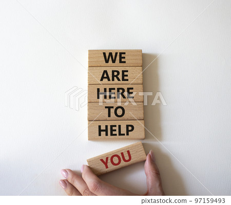 We are here to help you symbol. Concept words we are here to help you on wooden blocks. Beautiful white background. Businessman hand. Business and we are here to help you concept. Copy space. 97159493