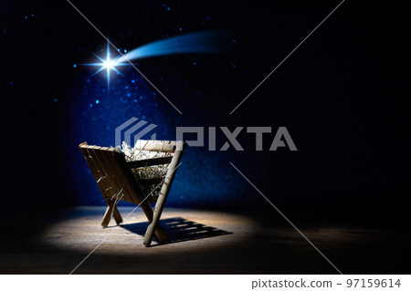 Nativity of Jesus, empty manger at night with bright lights. 97159614