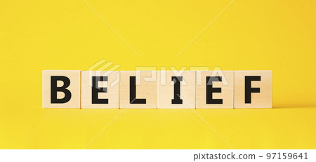 Belief symbol. Concept word Belief on wooden cubes. Beautiful yellow background. Business and Belief concept. Copy space. 97159641