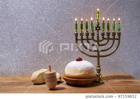 Jewish holiday Hanukkah background with menorah and dreidel with letters Gimel and Nun. Jewish holiday Hanukkah background with menorah and dreidel with letters Gimel and Nun. 97159652